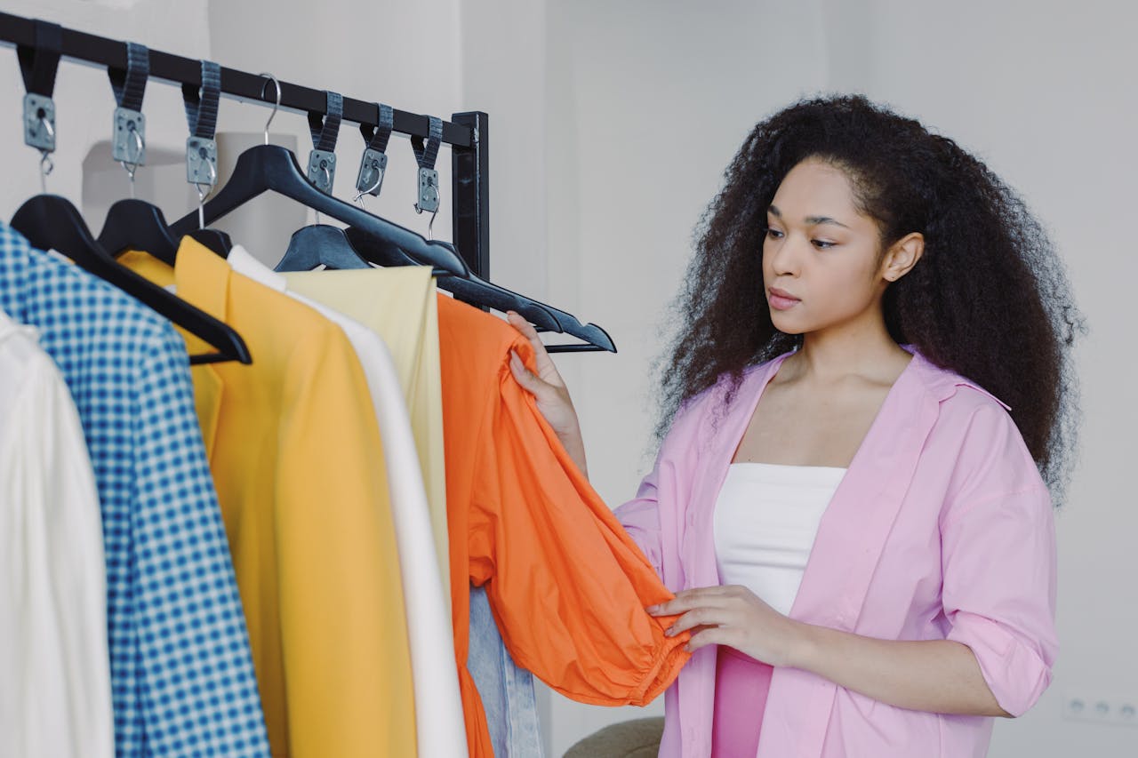 Crafting Captivating Headlines: Your awesome post title goes here Woman browsing colorful clothes in a boutique, exploring fashion options.